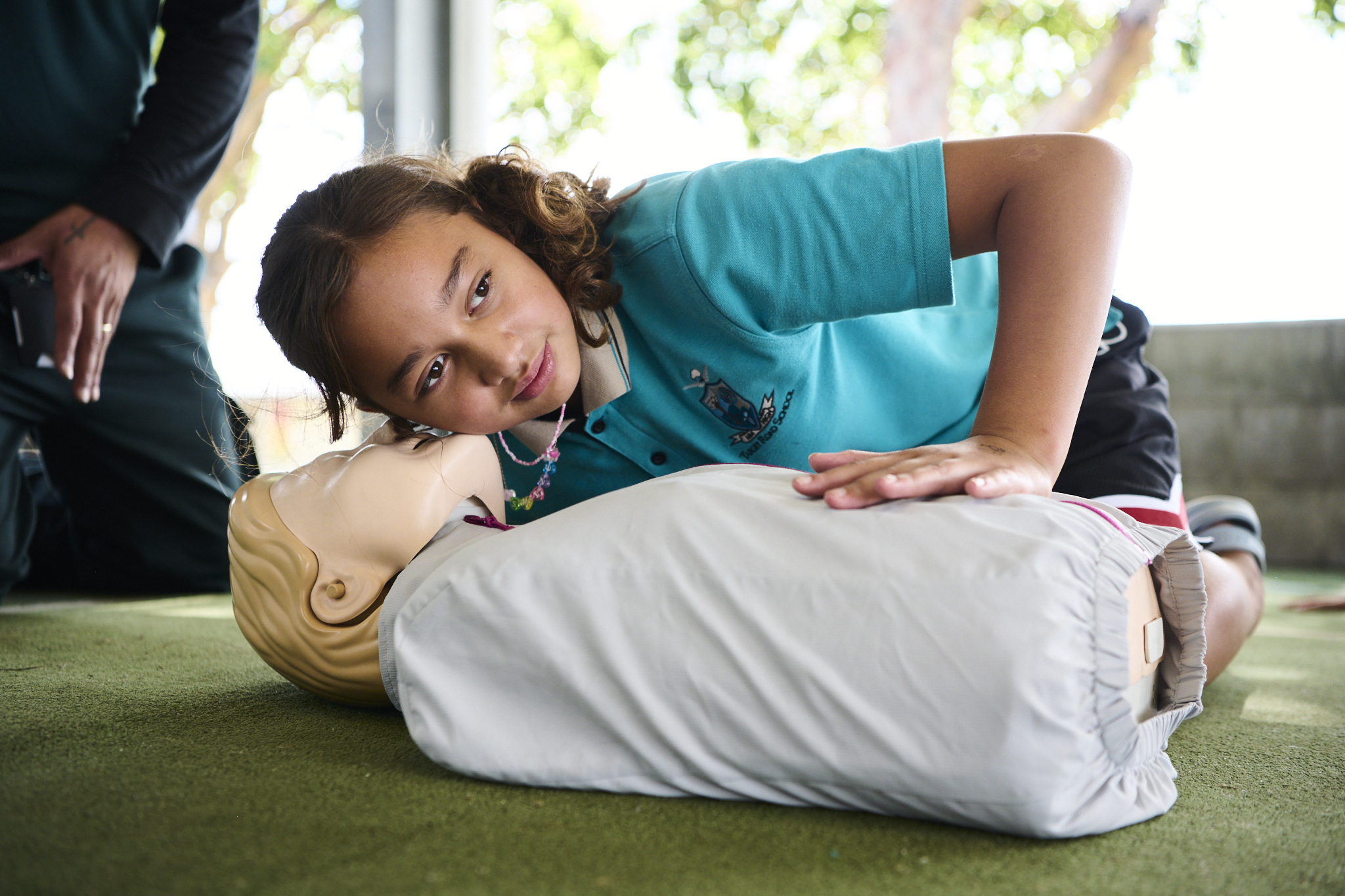 educator with primary school children teaching cpr